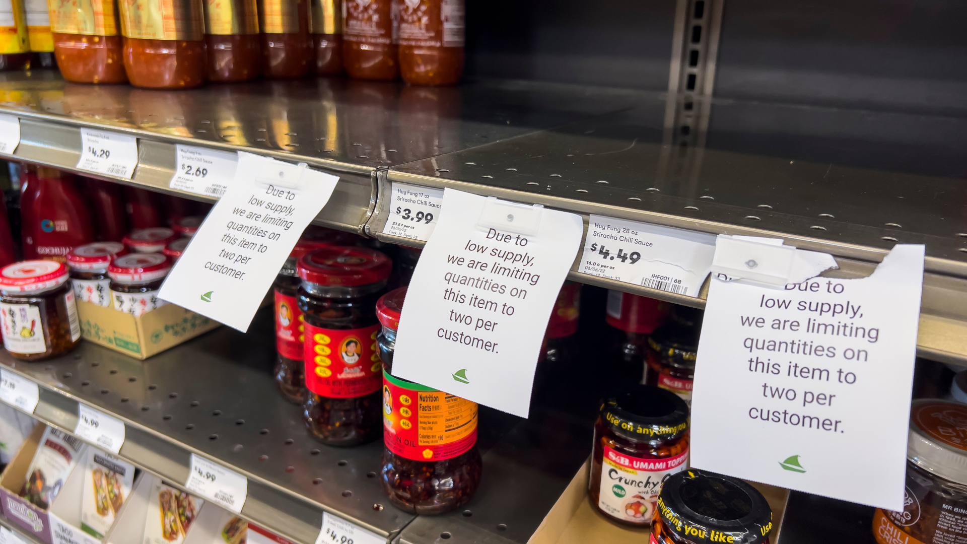 Grocery store shelf with sign saying that supply is limited