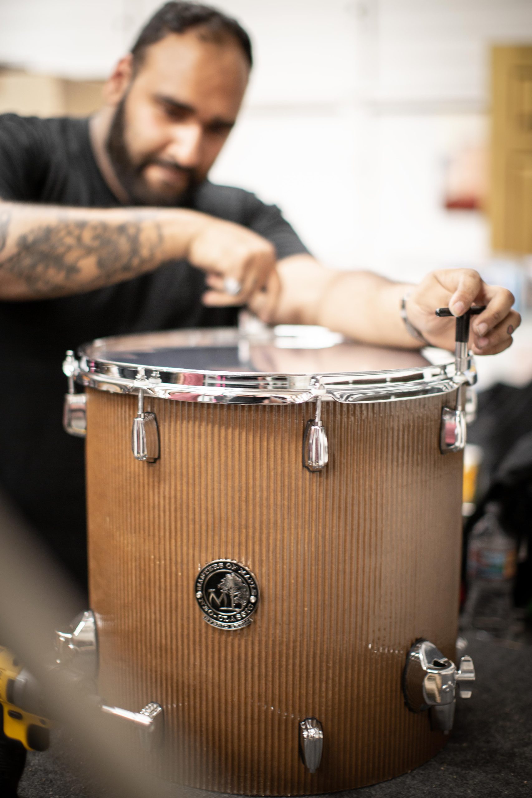 Sy Hanif tinkering with the cardboard drum