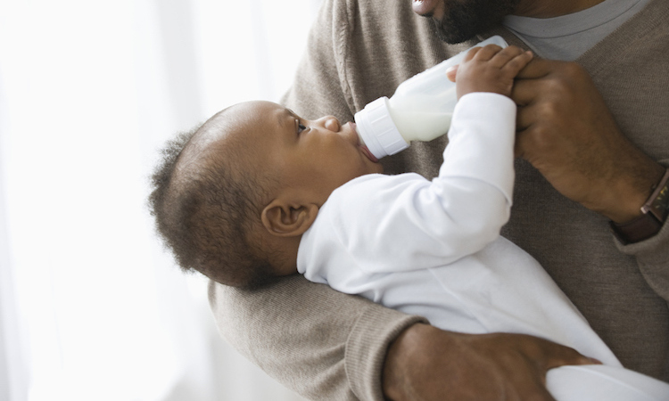 father bottlefeeding a baby