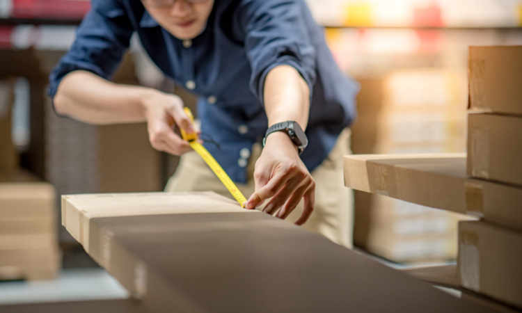 A man measures a package to prepare for SIOC