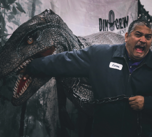 phoenix employee with dinosaur animatronic