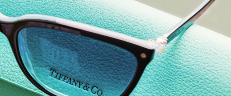 Tiffany & Co. designer eyeglasses resting on signature robin's egg blue leather packaging box