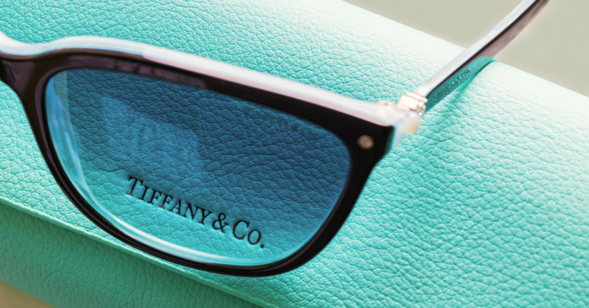 Tiffany & Co. designer eyeglasses resting on signature robin's egg blue leather packaging box