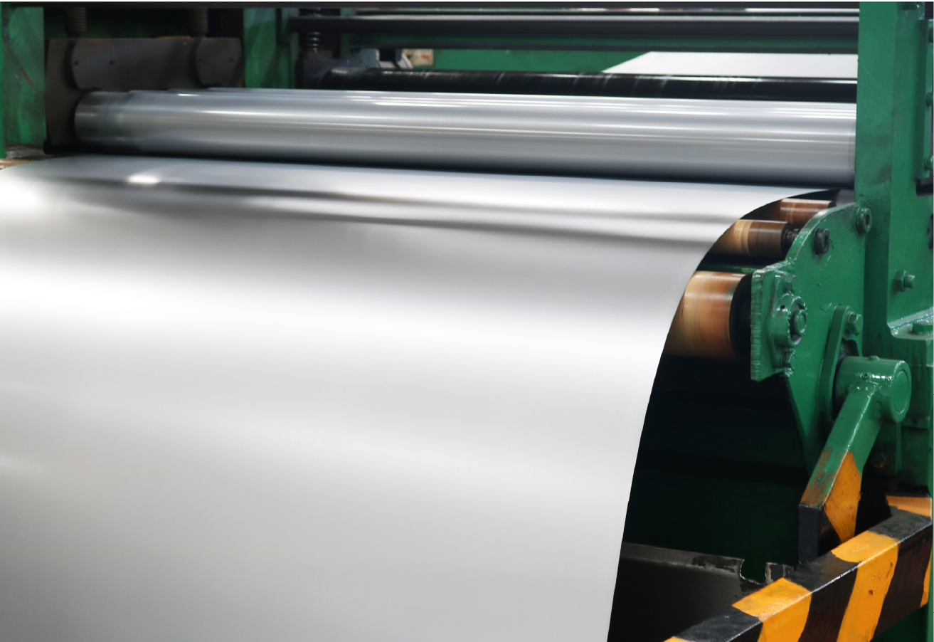 Industrial rolling machine processing sheet material in manufacturing facility