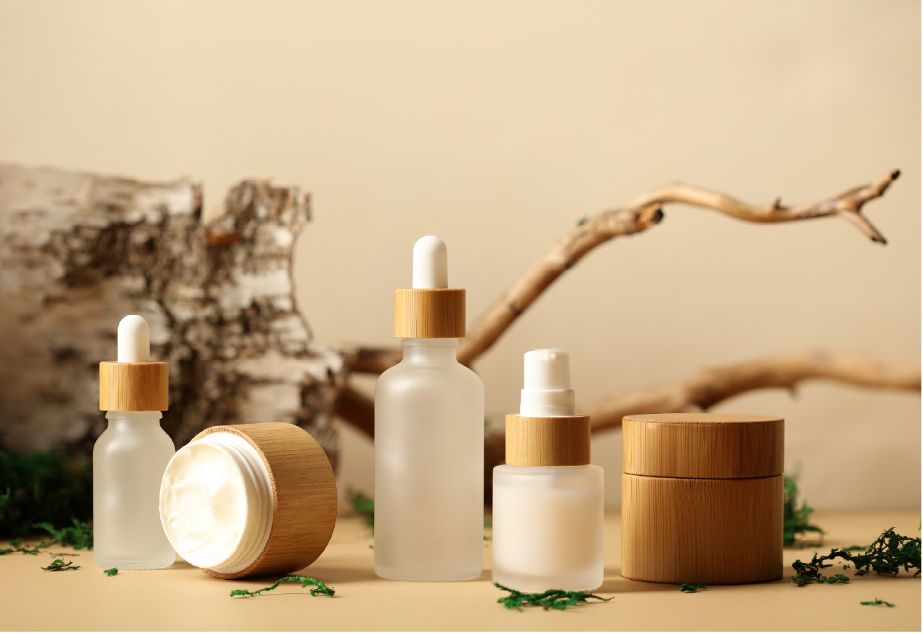 Natural cosmetic bottles with bamboo caps and driftwood display