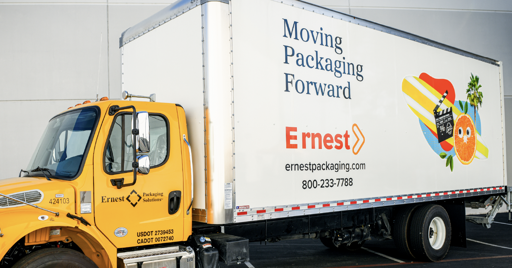 Yellow Ernest Packaging Solutions delivery truck with branded white trailer displaying company logo and contact information