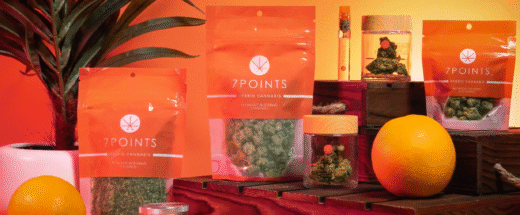 7Points hybrid cannabis products in orange transparent packaging displayed with oranges and plants.