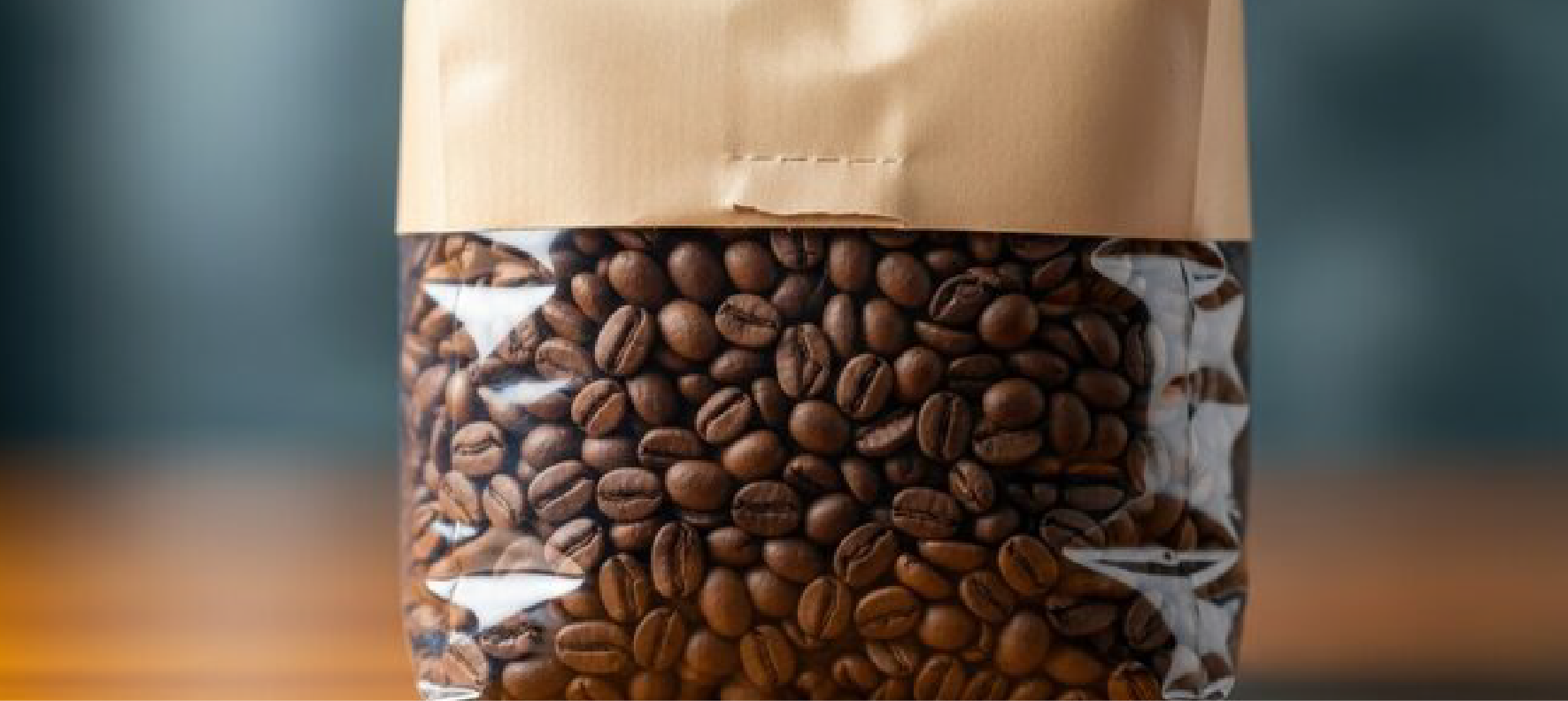 Coffee beans visible through transparent window in brown paper packaging bag.