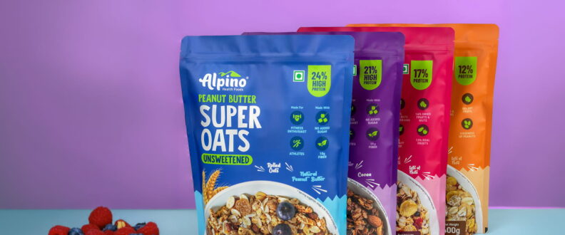 Four colorful Alpino Health Foods Super Oats pouches in blue, purple, pink, and orange, displayed with berries.