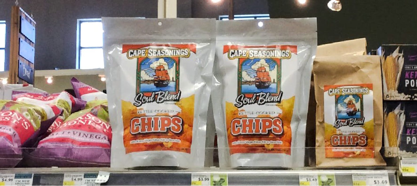 Cape Seasonings Soul Blend kettle-cooked chip bags displayed on a grocery store shelf alongside competing snack brands.