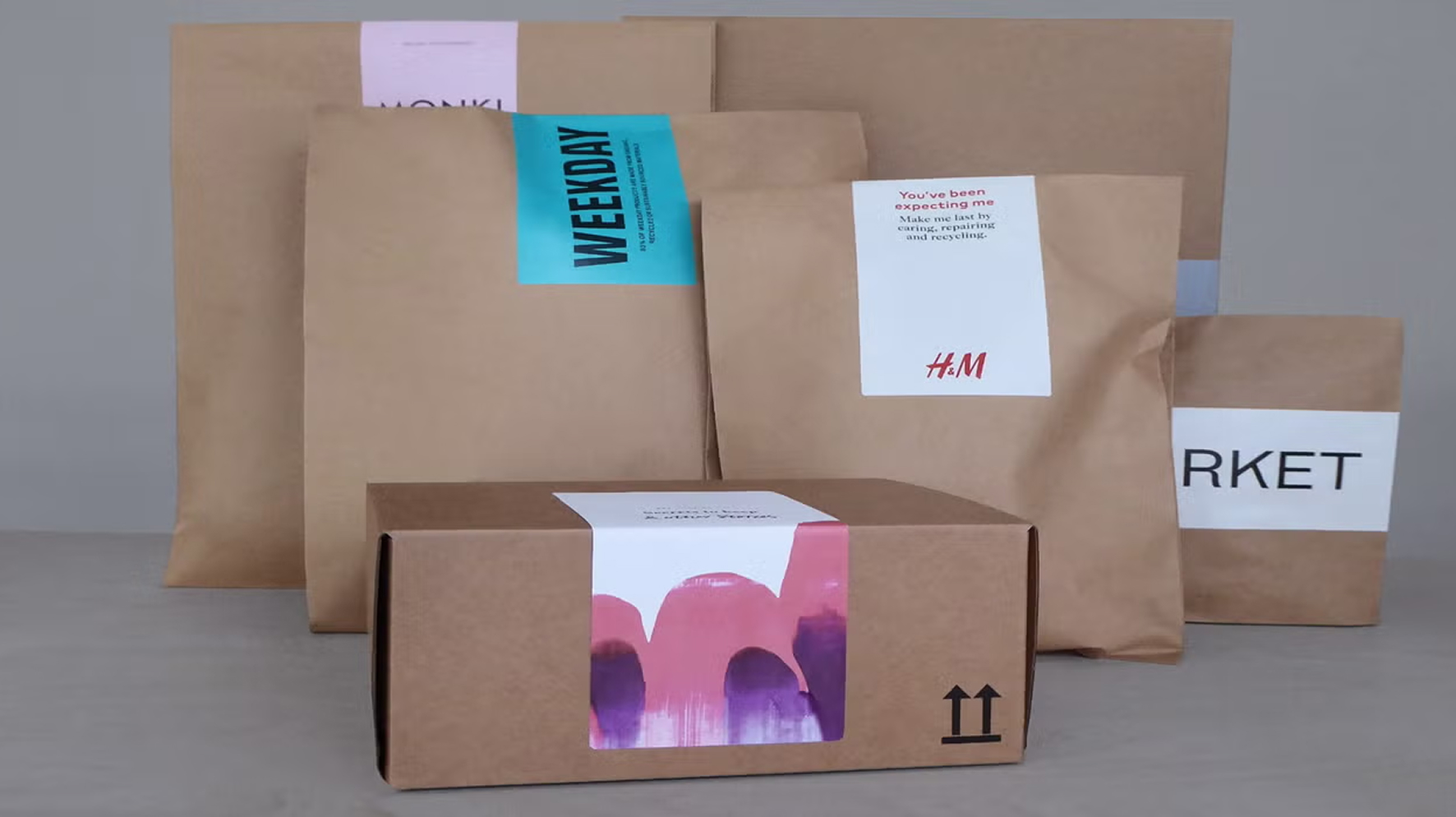 Paper apparel shipping packaging with various H&M brand labels